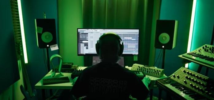 Capture of the "Sinking" music video where Enei is working on his track. in his studio